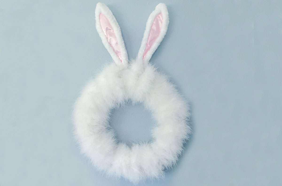 Closeup of an DIY Easter Bunny Wreath Easter Decoration hanging on a wall.