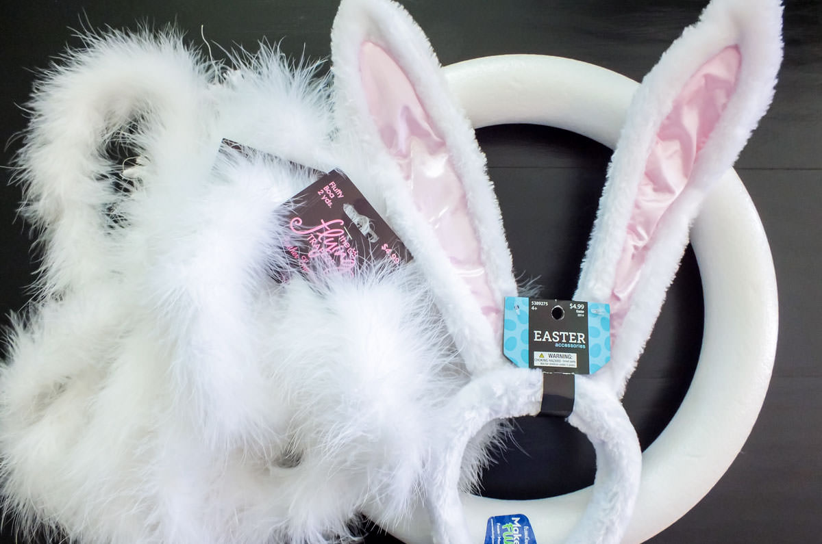 All the ingredients required to make a DIY Easter Bunny Wreath including a floral ring, Easter Bunny Headband and white feather boas.