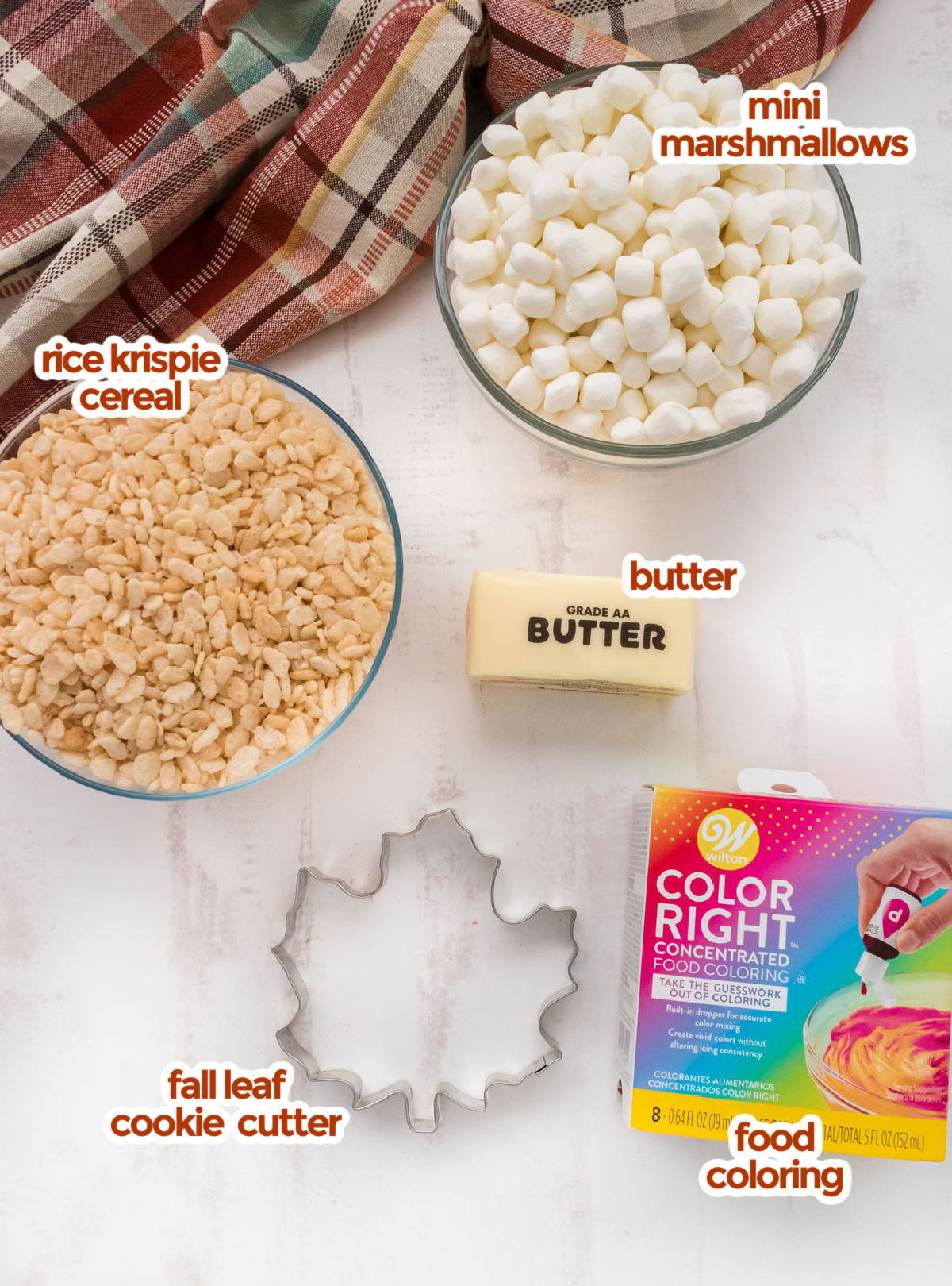 All the ingredients you will need to make Fall Leaves Rice Krispie Treats including Rice Krispie Cereal, Mini Marshmallows, Butter, Food Coloring and a Fall Leaf Cookie Cutter.