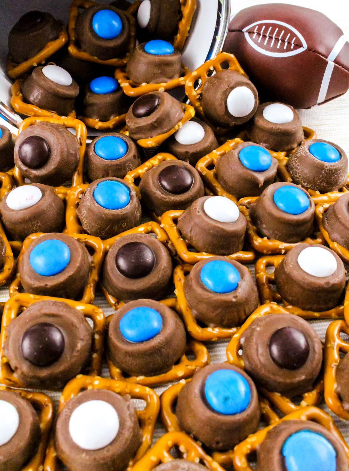 Closeup on a batch of Carolina Panthers Pretzel Bites spilling out of a white pail onto a white table.