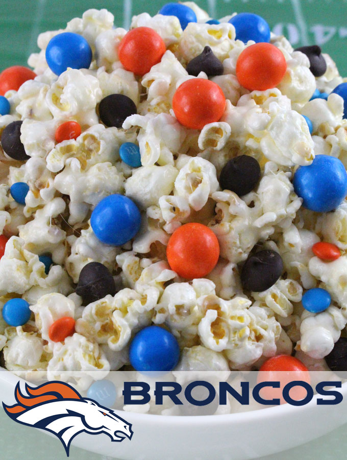 Denver Broncos Popcorn for those Denver Broncos fans in your life. Sweet, salty, crunchy and delicious and it is extremely easy to make. This delicious popcorn will be perfect at your next game day football party. a NFL playoff party or a Super Bowl party. Follow us for more fun Super Bowl Food Ideas.