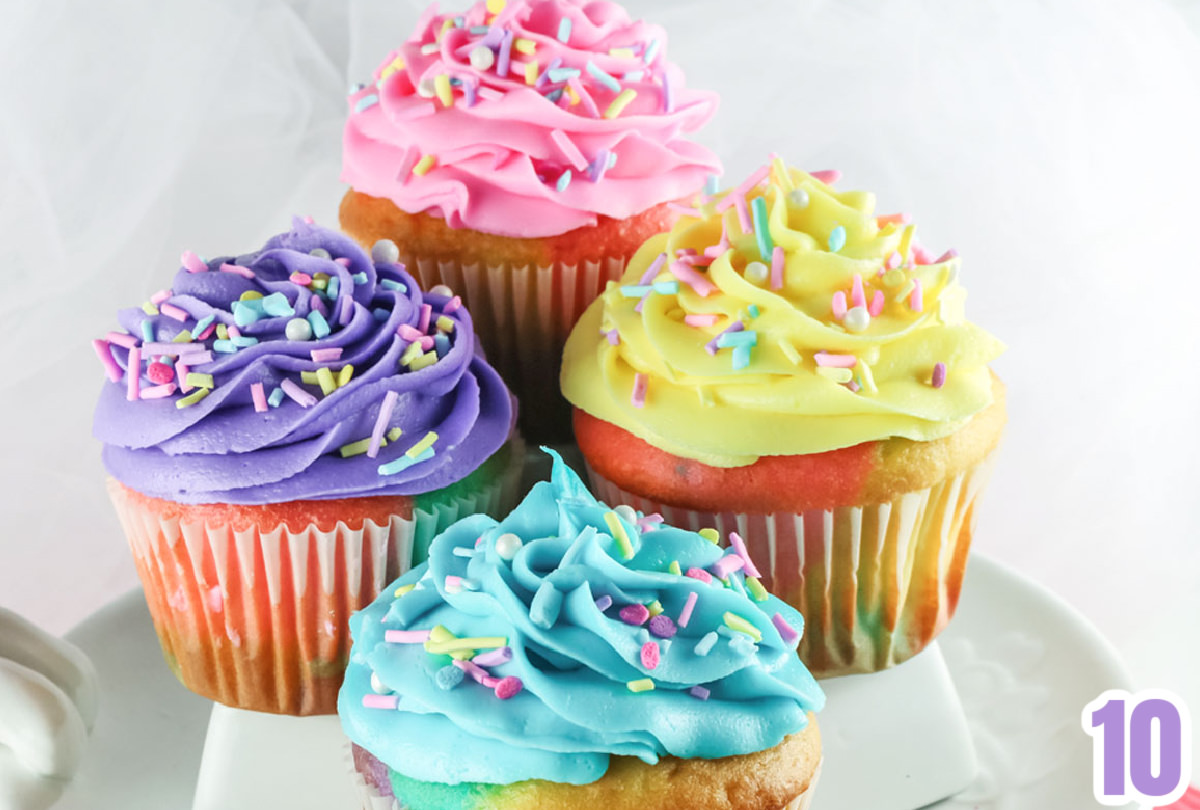 Closeup on the yellow, pink, purple and blue frosting swirls of Buttercream Frosting on the Celebration Marble Cupcakes.