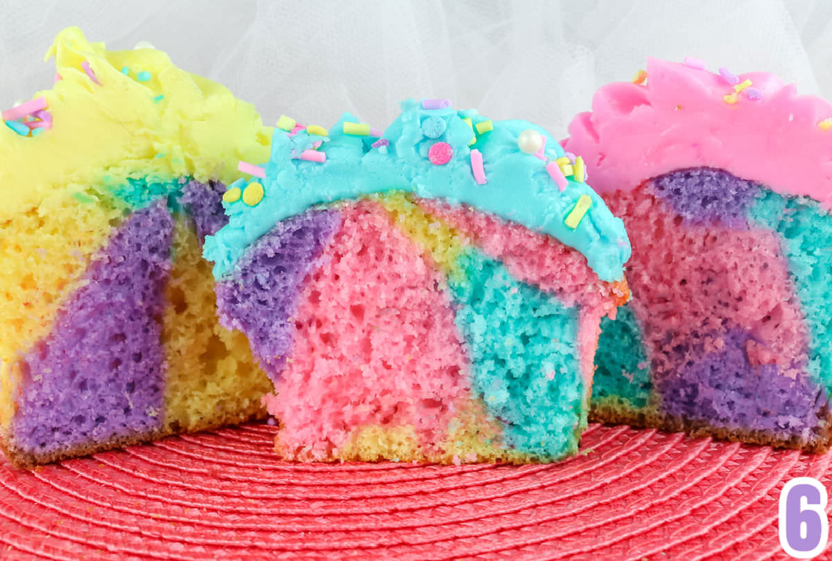 The insides of three cupcakes showing the varying marble patterns of each cupcake.